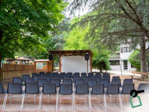 a group of chairs sitting in front of a stage at Hotiday Lago di Levico in Levico Terme