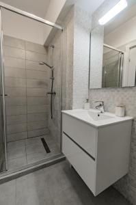 a bathroom with a white sink and a shower at Black Sea Booking - Helsinki in Năvodari +47 photos