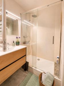 a bathroom with a shower and a sink at Pool 3 Balconies & Parking in La Baule +3 photos
