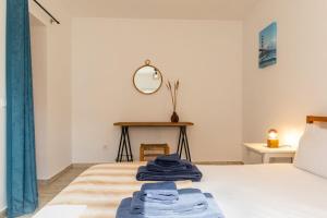 a bedroom with a bed with two blue towels on it at 1bd Apartment close to beach in Lourinhã +29 photos
