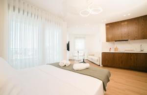 a bedroom with a large bed with towels on it at Rajna Apartments in Ulcinj