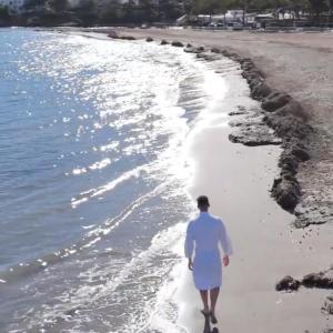 a man walking on the beach at Boutique Apartments Marsol Ibiza in Santa Eularia des Riu