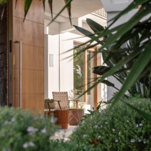 a porch of a house with a chair and plants at Boutique Apartments Marsol Ibiza in Santa Eularia des Riu +48 photos