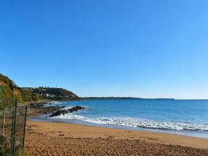a beach with the ocean on a sunny day at The Lodge, Whitethorns, Myrtleville in Myrtleville