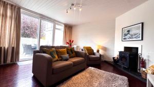 a living room with two chairs and a couch at The Lodge, Whitethorns, Myrtleville in Myrtleville