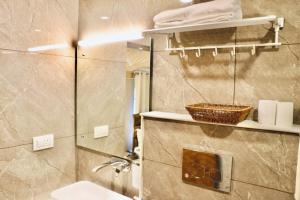 a bathroom with a shower and a sink and a toilet at SkyRidges in Srinagar +40 photos