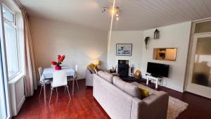 a living room with a couch and a table at The Lodge, Whitethorns, Myrtleville in Myrtleville +6 photos