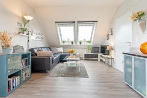 a living room with a couch and a table at Inselglück in Fehmarn