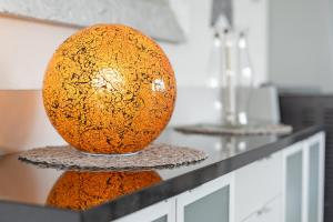 a large orange vase sitting on top of a counter at Inselglück in Fehmarn