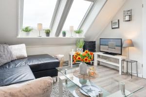 a living room with a couch and a tv at Inselglück in Fehmarn +31 photos
