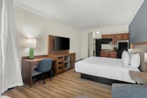 a hotel room with a bed and a desk with a computer at Hyatt Select Galveston Beachfront in Galveston