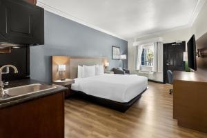 a hotel room with a bed and a sink at Hyatt Select Galveston Beachfront in Galveston +120 photos