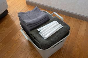 a suitcase filled with towels and a pile of towels at Seaside Deer Shiraoi in Shiraoi +65 photos