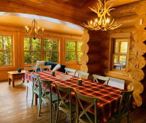 a dining room with a long table and chairs at Blue Bear Spa sauna private pool lake access in Wentworth +48 photos