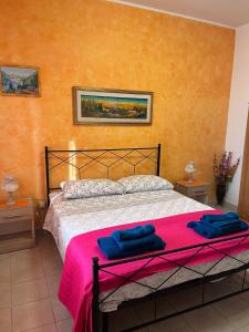 a bedroom with a bed with two blue towels on it at Dream Beach Salento in Porto Cesareo