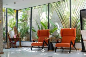 two chairs and a table in a room with plants at OCEAN HOTEL in Phnom Penh