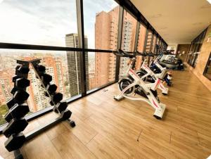 a gym with treadmills and exercise bikes in a building at Distrito prime 1-303 in Bogotá