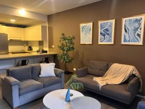 a living room with two couches and a kitchen at Distrito prime 1-303 in Bogotá