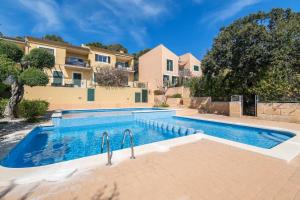 a swimming pool in front of a house at Casa Es Putxet in Cala Ratjada