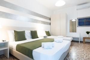a white bedroom with two beds and a table at B&B K Beach Lake Endine in Endine Gaiano +43 photos