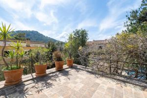 a balcony with potted plants and a fence at Casa Es Putxet in Cala Ratjada