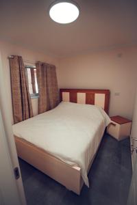 a bedroom with a large white bed and a window at carmel cabins suite 7 in Yājur +16 photos