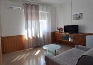a living room with a couch and a table and a television at Affitta camere Via Piave in Foligno +35 photos