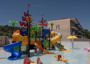 a playground with many different types of play equipment in the water at Royal Hotel and Suites in Polychrono