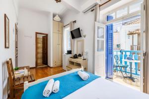 a bedroom with a bed and a balcony at Adonis Rooms in Skopelos Town