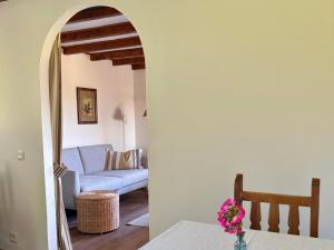 a living room with a blue couch and a table at El Balcón Del Profesor in Cereceda