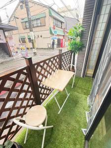 a small balcony with a table and chairs on it at 雅 in Kyoto