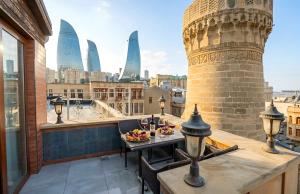 a balcony with a table and a view of the city at West inn Luxury Baku in Baku