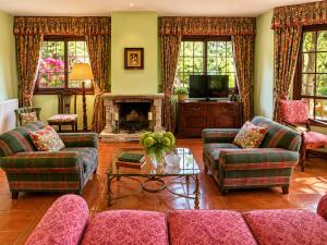 a living room with a couch and a fireplace at Holibai As Landras Piscina y vistas al Miño, Tomiño in Tomiño