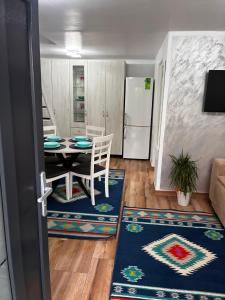 a dining room with a table and a kitchen at Sofia's home in Piatra Neamţ