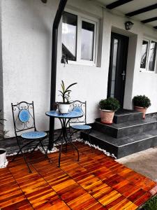 a patio with two chairs and a table on a porch at Sofia's home in Piatra Neamţ +12 photos