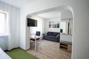 a living room with a couch and a table at Hotel Villa Sulmana in Neckarsulm