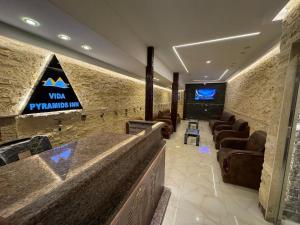 a waiting room with couches and a sign on the wall at Vida Pyramids Inn in Cairo