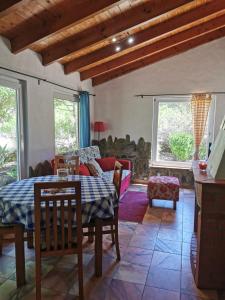a living room with a table and a couch at Quinta do Paraiso in São Teotónio