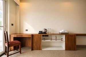 a wooden desk with a chair in a room at Anuttara Retreat in Narendranagar