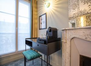 a black dresser with a microwave and a stool at ELSA, Hôtel Paris by Collection Vesper in Paris