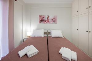 a bedroom with a large bed with two white pillows at Makis Apartments in Tsoukalades