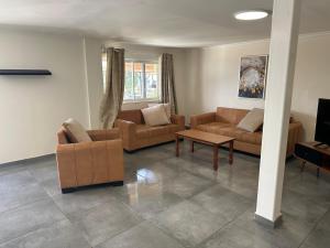 a living room with two couches and a table at carmel cabins suite nu 8 in Haifa