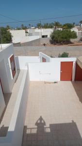 a shadow of a house on the side of a building at Najib in Djerba
