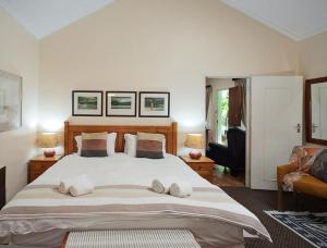 a bedroom with a large bed with two pillows at Great Dane at Brittlewood in Underberg