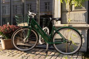 a green bike parked in front of a building at Axel Guldsmeden in Copenhagen +88 photos