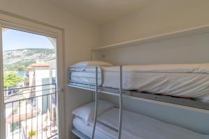 a bedroom with a bunk bed and a balcony at Casa Bortolo in Garda