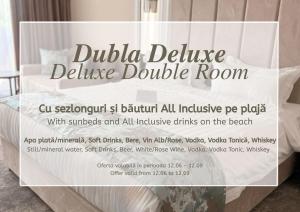 a sign for a dudida deluxe pillow double room at Panoramic Mamaia Hotel in Mamaia