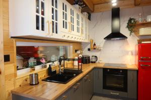 a kitchen with wooden counters and a red refrigerator at Mazury Czerwony Domek Jacuzzi in Romany