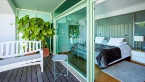 a bedroom with a bed and a glass wall at Sea view Luxury Apartment in Paço de Arcos +41 photos