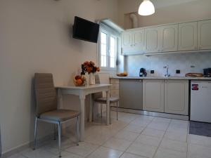 a kitchen with a table and chairs and a sink at Sandra's Nest Gaios Paxos in Gaios